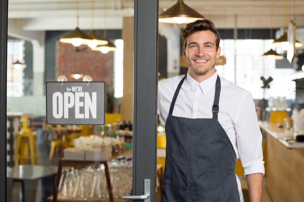 Shop owner standing in doorway